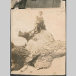 Woman and dog sitting on rock (ddr-densho-523-49)