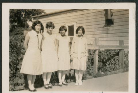 four girls in front of railing (ddr-densho-378-680)