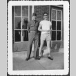 Two men standing outside building (ddr-densho-434-446)