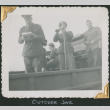 Man reading from papers, with horn player standing behind (ddr-densho-434-81)