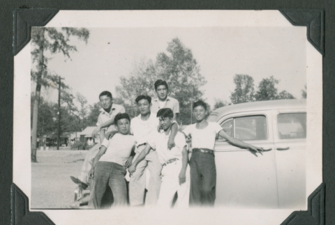 Six men leaning against a car (ddr-densho-471-81)