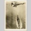 Photograph of a plane flying over a submarine (ddr-njpa-13-567)