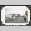 Men playing football on field (ddr-densho-475-706)