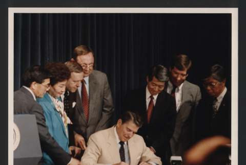 Photograph of President Ronald Reagan signing Redress H.R. 442 (ddr-csujad-55-2619)