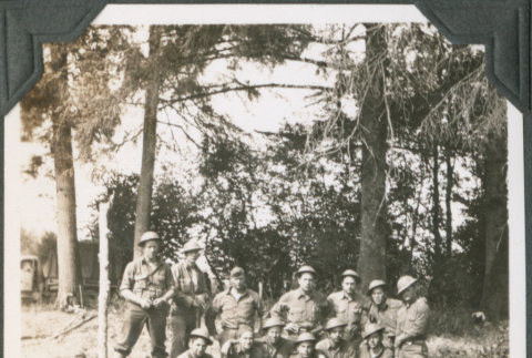 Group of men in uniform posing by trees (ddr-ajah-2-231)