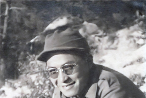Shiro Robert Yamaguchi sitting in snow eating (ddr-densho-474-226)