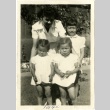 A woman and three girls in front of barracks (ddr-manz-6-60)