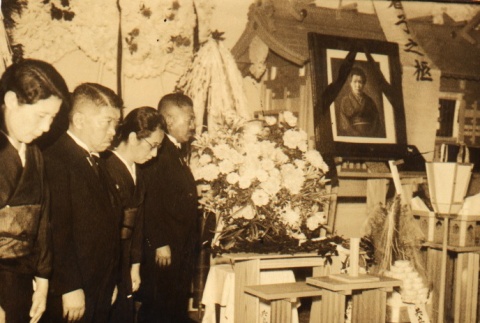 Two men and two women standing at a funeral altar (ddr-njpa-4-66)