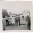 Group standing by fence at airport (ddr-densho-426-865)