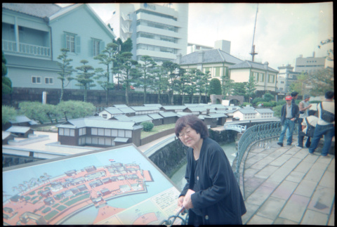 Tomoye Takahashi standing by model of Dejima Island (ddr-densho-426-506)