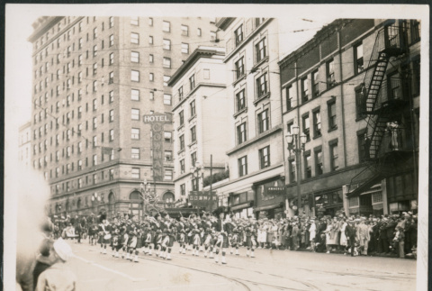 Bagpipers in parade passing Hotel Gowman in Seattle (ddr-densho-483-555)