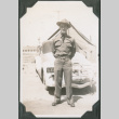 Man in uniform standing by car (ddr-ajah-2-63)