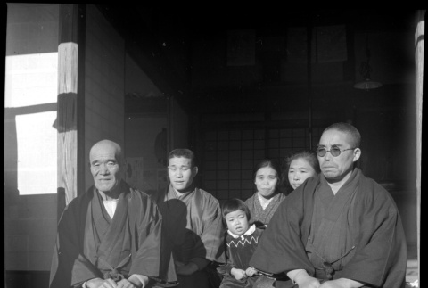 Family seated outside house (ddr-densho-426-309)