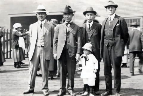 Four men and a boy with crowd in background (ddr-densho-474-217)