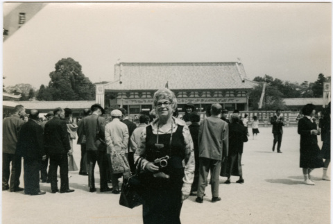 Woman with camera in courtyard (ddr-densho-426-1076)