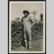 man by wood pile (ddr-densho-378-358)
