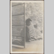 Woman sitting on porch (ddr-densho-278-245)
