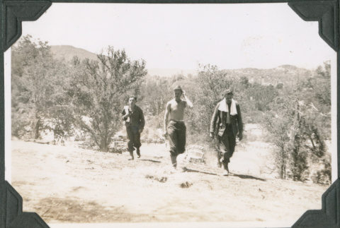 Three men with towels walking through field (ddr-ajah-2-202)