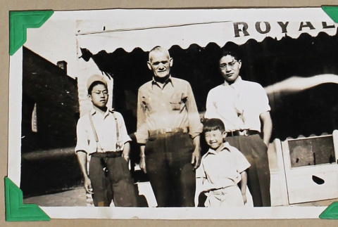 Three men and a boy stand outside the Royal Cafe (ddr-densho-404-360)