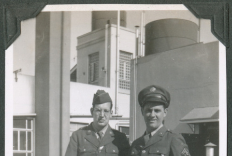 Two men in uniform leaning against wall (ddr-ajah-2-600)