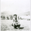 Boy squatting in field (ddr-densho-1007-774)