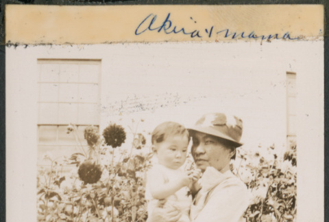 Woman holding baby in garden (ddr-densho-483-642)