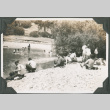 Men sitting next to creek, some men in creek (ddr-ajah-2-196)
