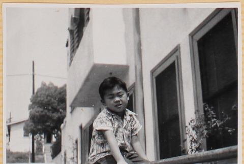 William Shiomi sitting on railing (ddr-densho-522-255)