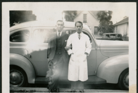 Two men pose with car (ddr-densho-359-1008)