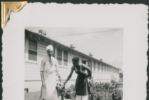 Two African American men in aprons with dog.  Edgar Jett on left (ddr-densho-434-177)
