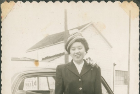 Woman standing in front of a car (ddr-densho-321-1115)