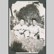 Two men sitting in grass (ddr-ajah-2-582)
