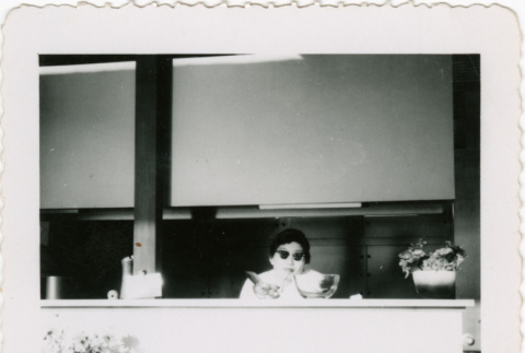 Woman behind counter at restaurant (ddr-densho-426-823)