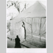Soldier peeking out of tent (ddr-densho-1007-865)