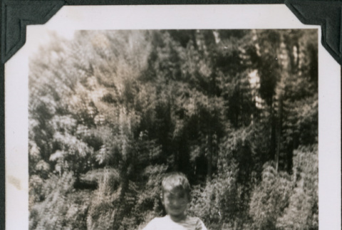 Photo of a child at a grave stone (ddr-densho-483-1328)