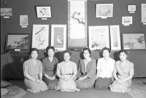 Women sitting in front of an art exhibit (ddr-fom-1-688)