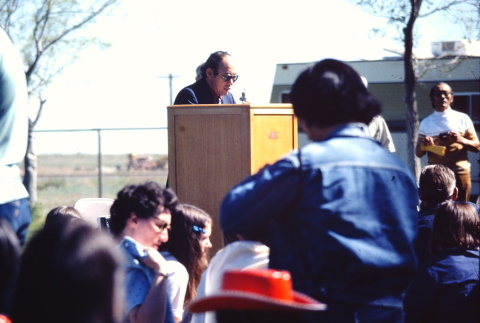 A man speaking at a remembrance program (ddr-densho-294-72)