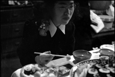 Tomoye (Nozawa) Takahashi at table eating (ddr-densho-426-1698)