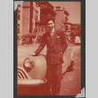 A man standing in front of a car (ddr-densho-298-138)