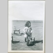 A toddler riding a tricycle (ddr-densho-300-82)