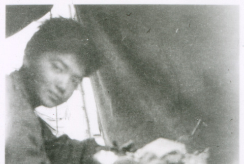 Man at table in tent (ddr-densho-1007-855)