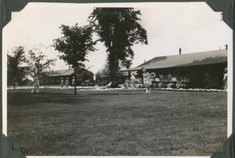 Band and majorettes in yard outside camp buildings (ddr-ajah-2-519)