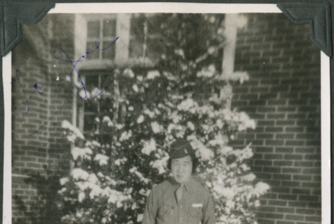 Man standing in snow outside building (ddr-ajah-2-390)