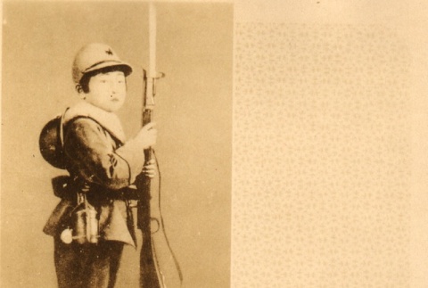 Boy posing with toy gun and military uniform (ddr-njpa-4-2638)