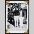 Two men pose beside a car (ddr-densho-404-160)