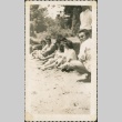 Group sitting on grass (ddr-densho-321-280)
