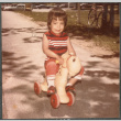 Girl riding toy horse (ddr-densho-523-590)