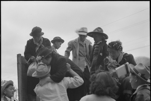 Japanese American family arriving at bus station (ddr-densho-151-168)