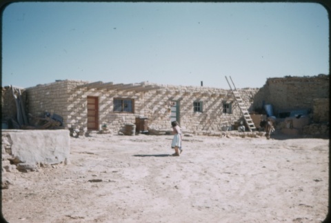 Girl in front of a desert building (ddr-densho-338-493)