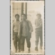Three teenage boys walking down the street (ddr-densho-321-1025)